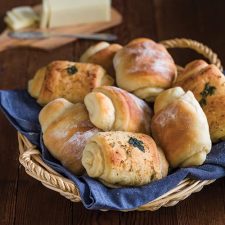 Spiral bread rolls in basket lined with blue napkin