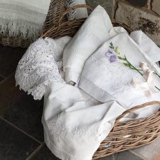 floral white linens in woven basket