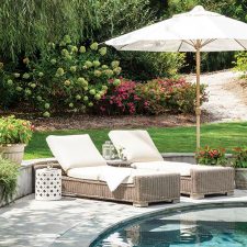 Neutral pool chairs under umbrella pool side